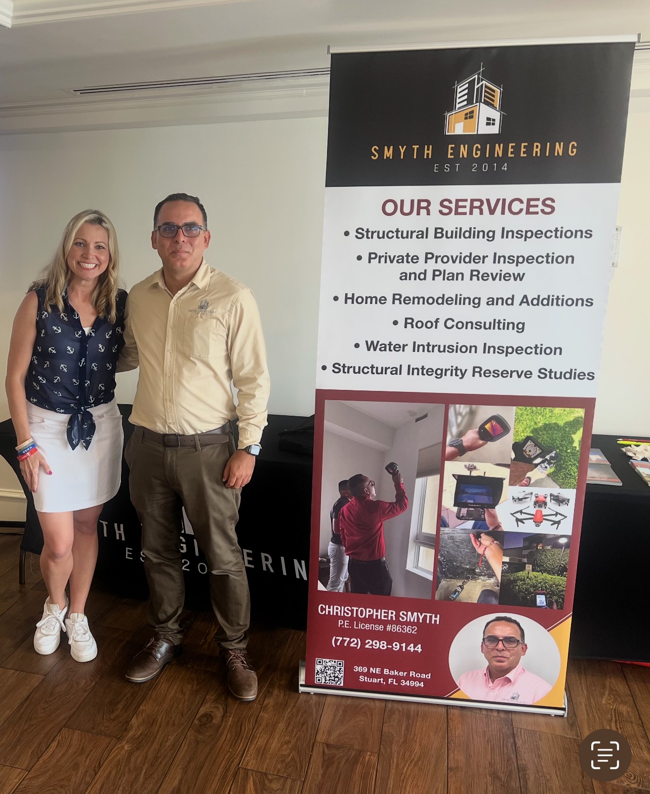 People sitting at tables at a night outdoor event with a vintage van in the background.
